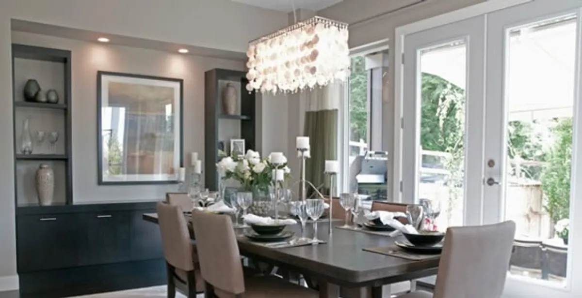 Elegant dining room chandelier installation above table in Bellevue, NE