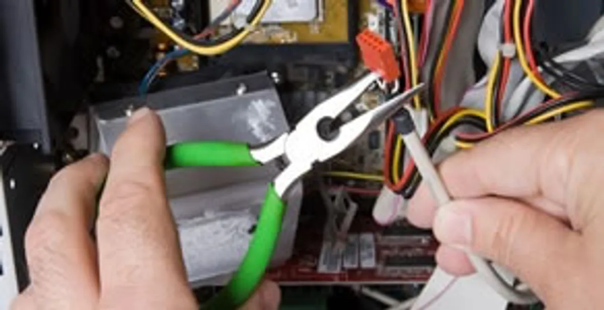Licensed electrical contractor performing electrical repair with tools in Plattsmouth, NE
